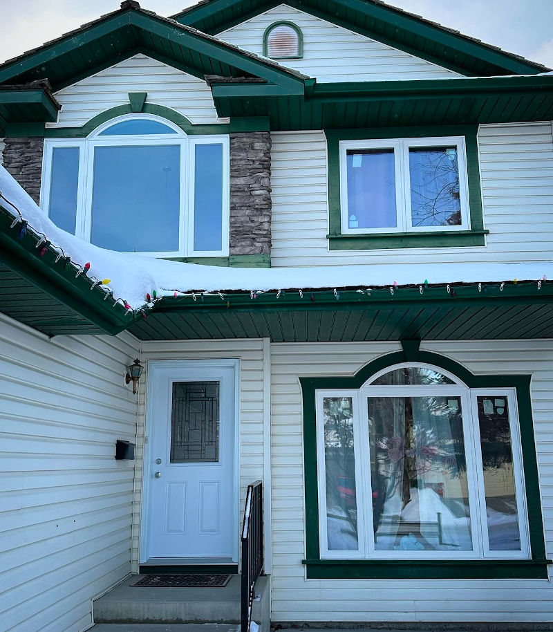 Homeowner reviewing CEIP financing and rebate programs for window replacement in Calgary