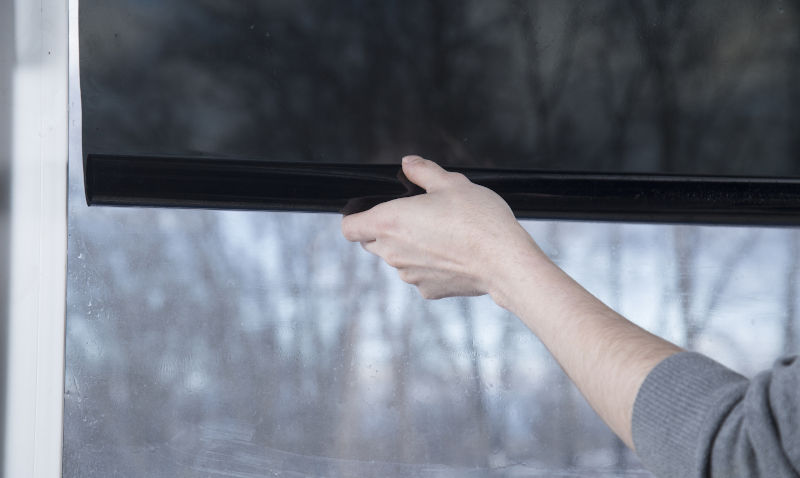 Professional installation of privacy window film for light control and visibility reduction