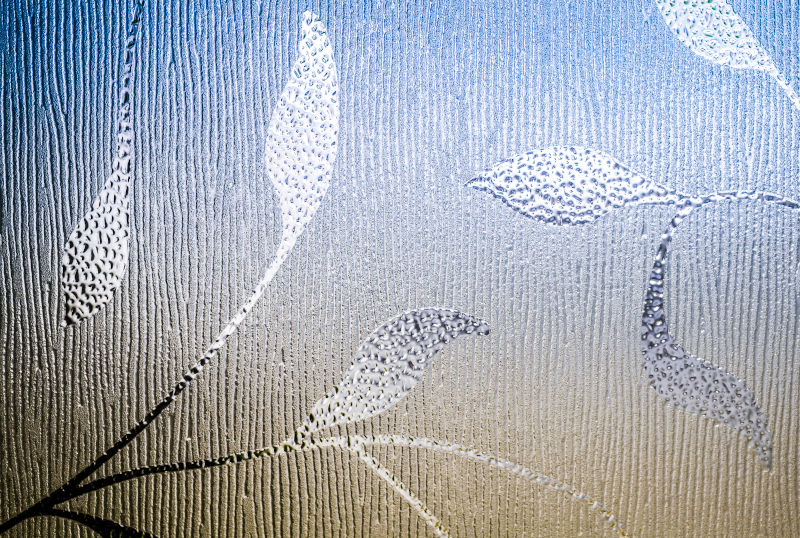 Decorative etched glass with a custom pattern providing privacy and visual interest