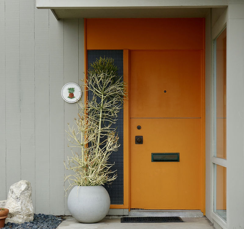 Bold modern front door in a vibrant colour on a contemporary home exterior