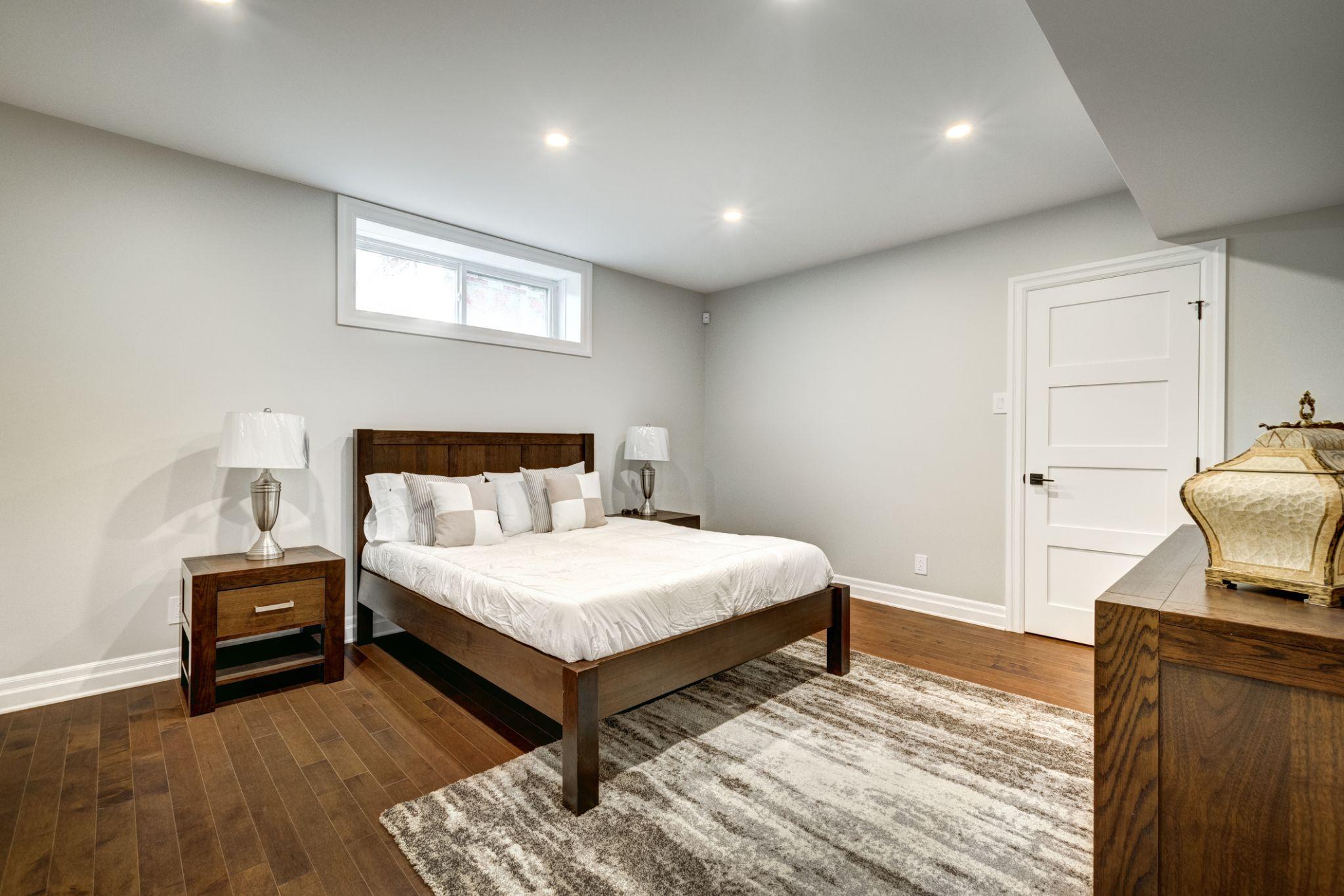 Finished basement with a newly installed window, illustrating the result of a professional basement window installation from planning to completion.
