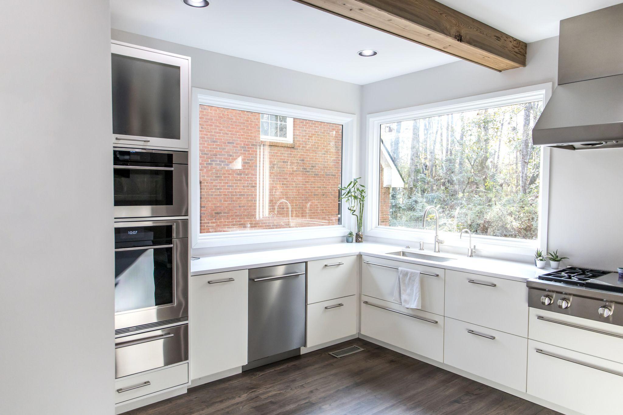 Modern home with newly installed replacement windows, illustrating the importance of proper window installation to prevent air leaks and improve energy efficiency.