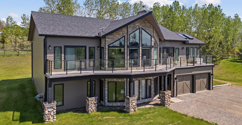 Rear exterior of the Foothills Estates home with shaped windows beneath the roofline